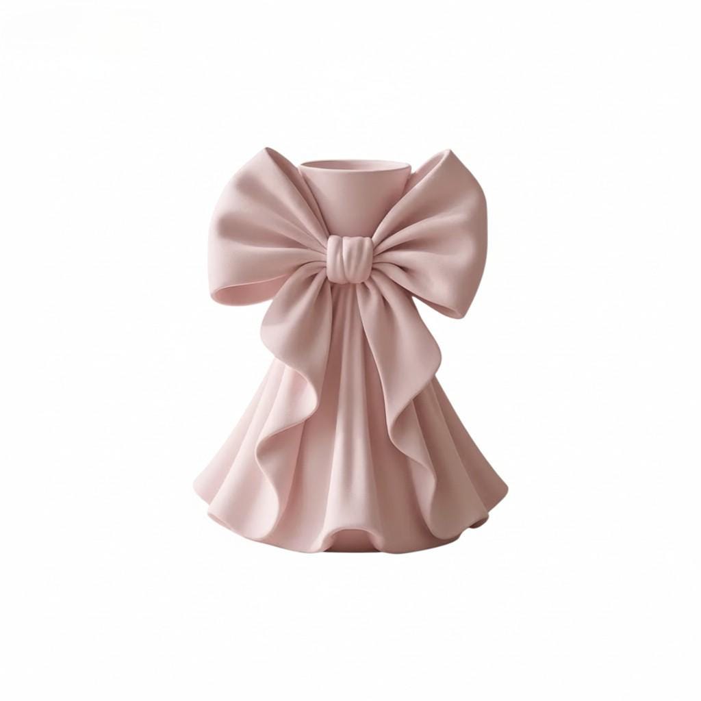 Coquette bow vase with pleated fabric-style design in soft pink on a vanity table
Romantic bow flower vase styled with roses and feminine home decor
Sculptural bow vase with matte finish for bridal and coquette interiors
Feminine decorative vase with gift-inspired silhouette and elegant bow
 Soft aesthetic flower vase designed for romantic and luxury spaces