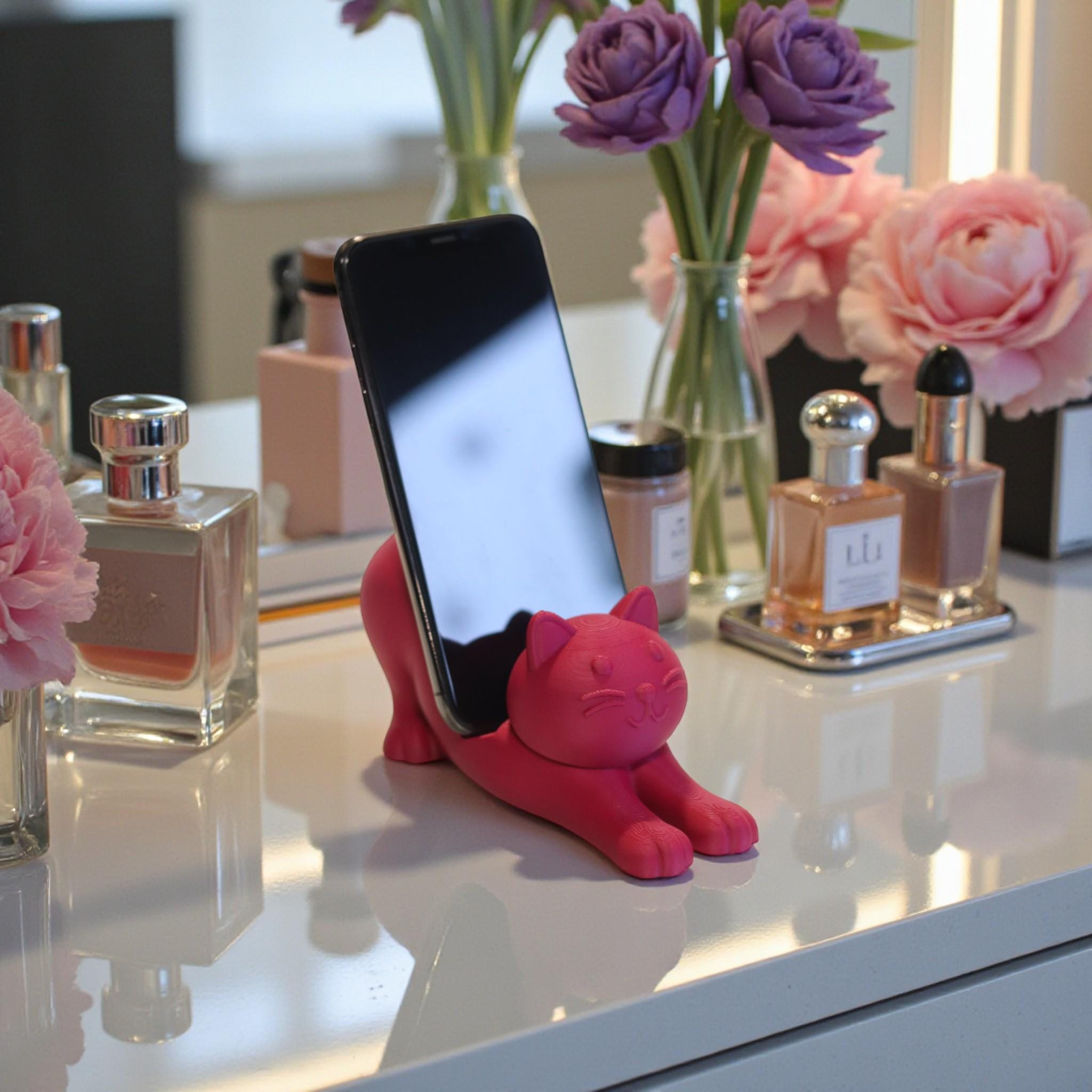 This cute cat phone stand holder is perfect for keeping your smartphone upright on your desk while adding a fun decoration for cat lovers.