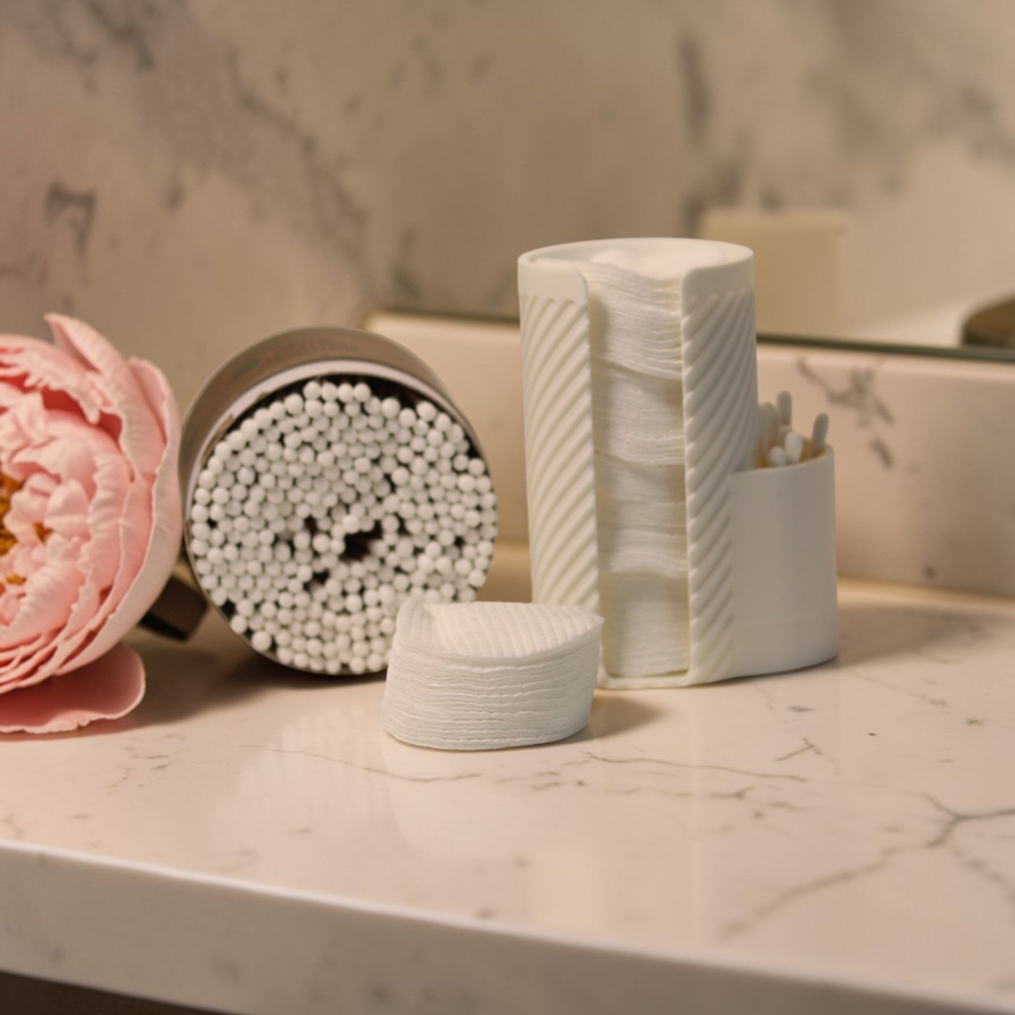 White makeup cotton pad holder with side cup for cotton buds on a vanity; minimal bathroom organizer for cotton rounds and Q-tips.