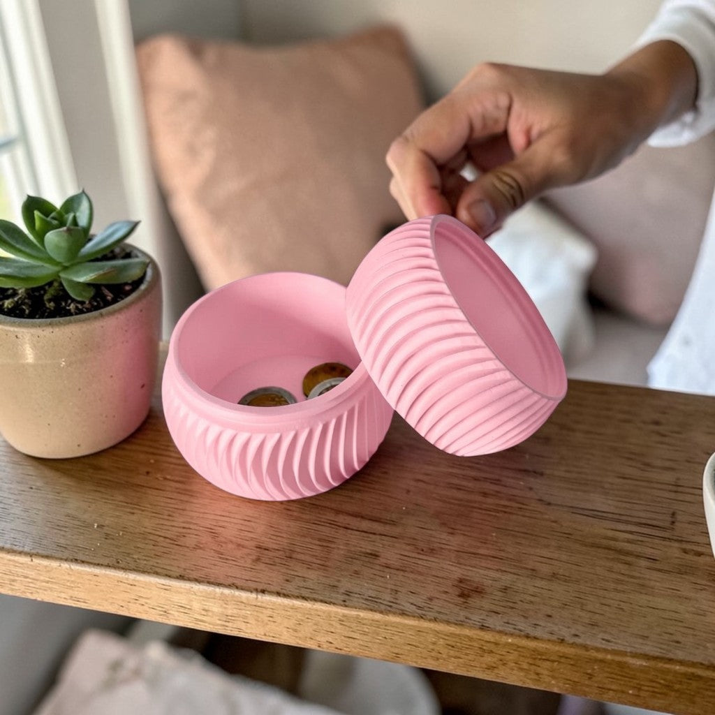 A modern 3D-printed coin bank with a sleek, openable design, available in two sizes. Perfect for storing coins and cash securely while adding a stylish touch to any home or office. Ideal for kids, adults, and as a unique gift for savers.
