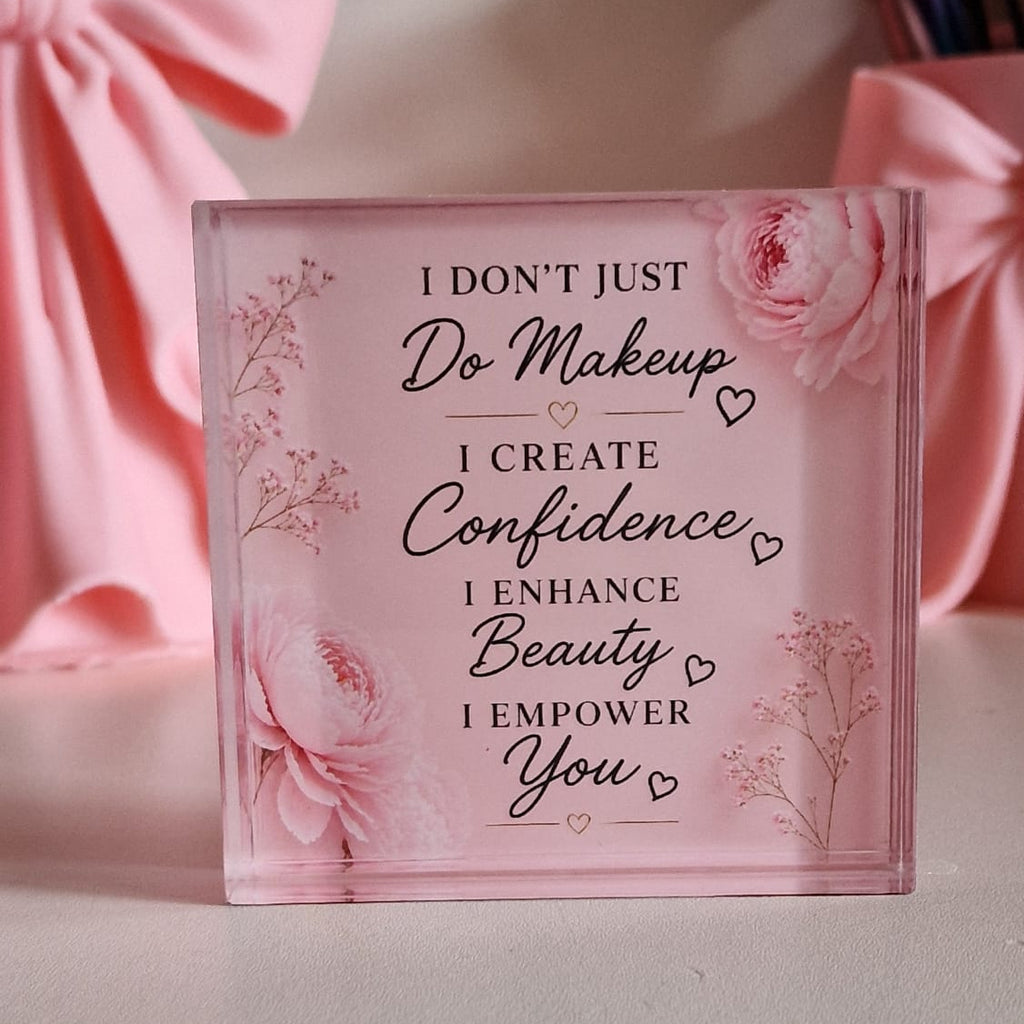 Pink glass block with motivational quote on a light pink background