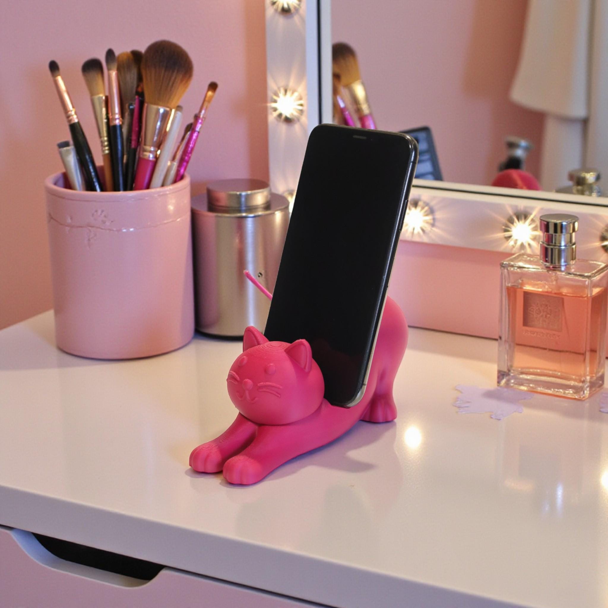 This cute cat phone stand holder is perfect for keeping your smartphone upright on your desk while adding a fun decoration for cat lovers.