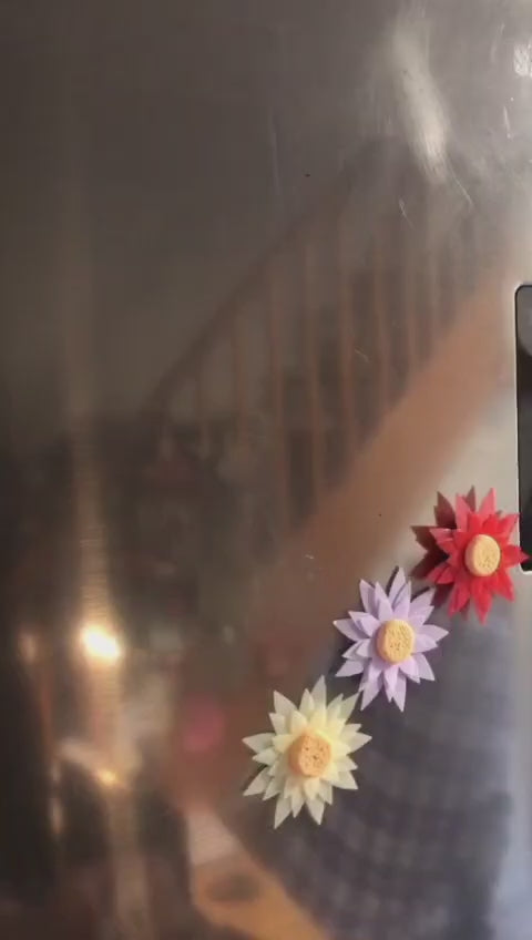 Child handing a tiny flower to their mom, with a magnetic mini vase on the fridge in the background—capturing a heartwarming everyday moment