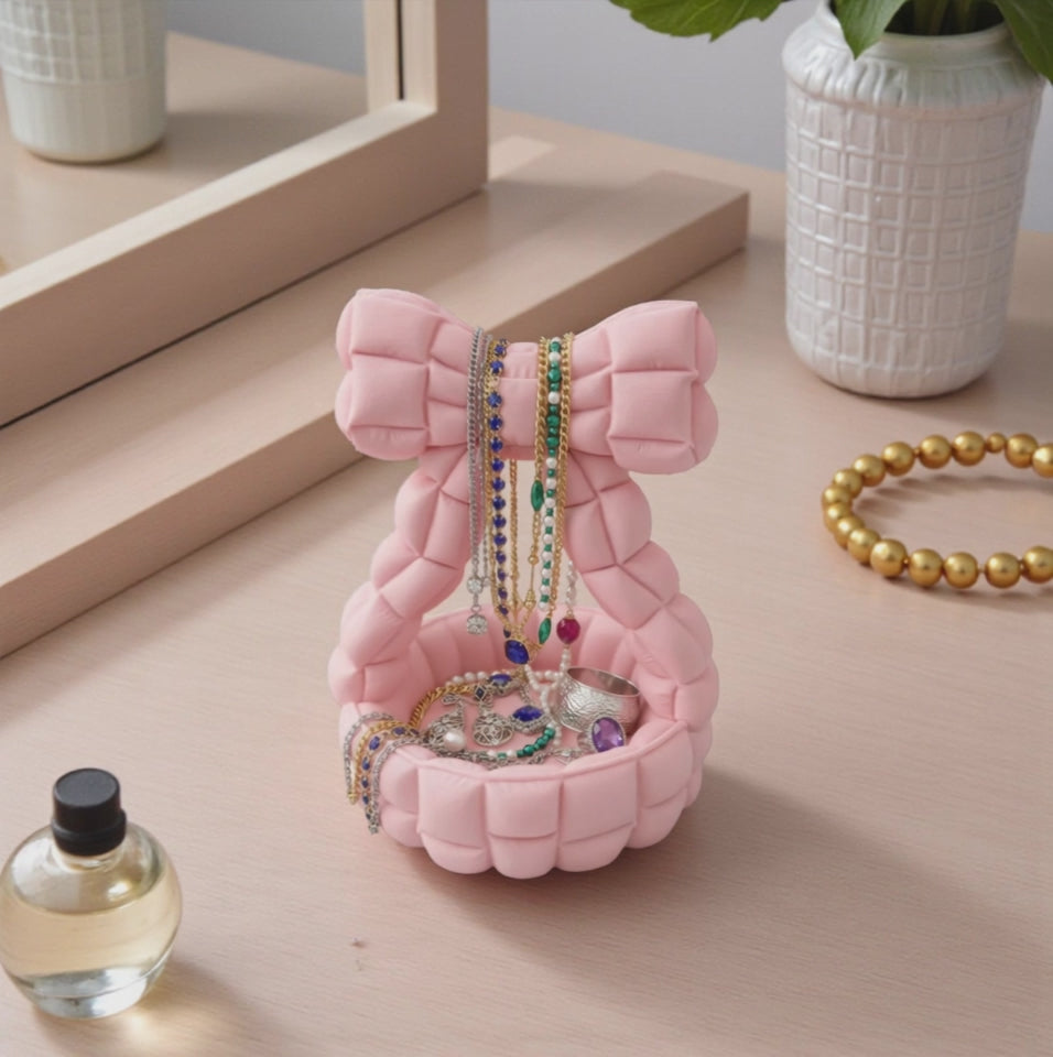 Quilted bow catchall basket used as jewelry dish on vanity, cute aesthetic decor
Pink bow jewelry holder with padded handle, decorative trinket dish for nightstand
Bow shaped quilted basket for rings and earrings, feminine desk and vanity organizer
Aesthetic bow catchall basket with quilted texture, stylish storage for small essentials