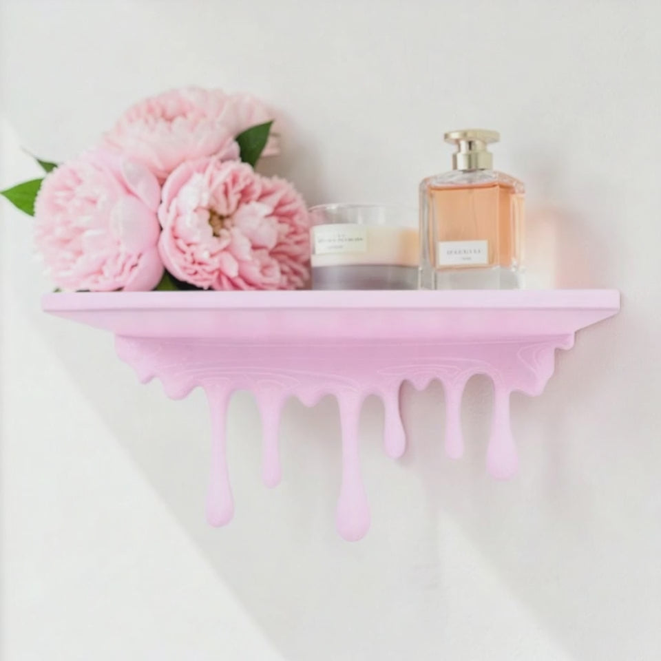 Modern dripping wall shelf with a unique flowing design, mounted on a white wall, showcasing minimalist decor and providing stylish storage for books, plants, or decorative items.