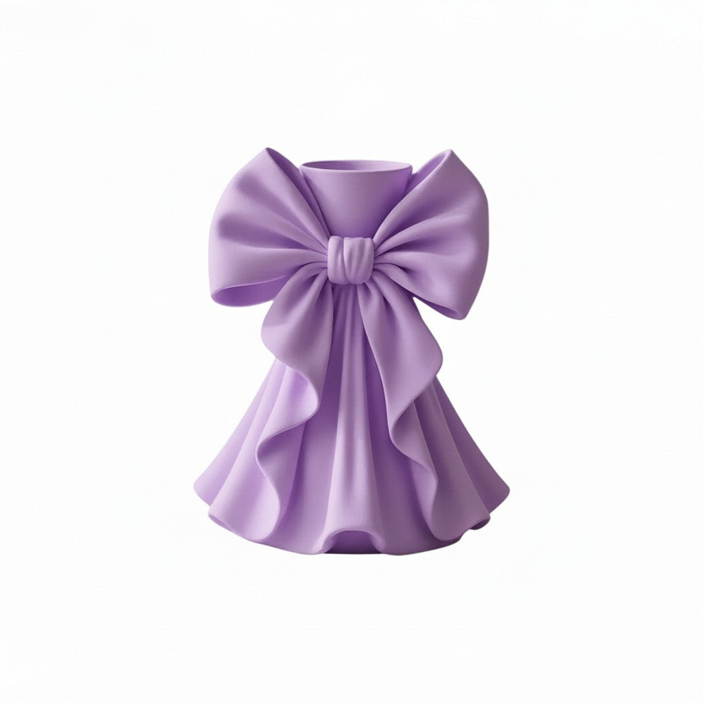 Coquette bow vase with pleated fabric-style design in soft pink on a vanity table
Romantic bow flower vase styled with roses and feminine home decor
Sculptural bow vase with matte finish for bridal and coquette interiors
Feminine decorative vase with gift-inspired silhouette and elegant bow
 Soft aesthetic flower vase designed for romantic and luxury spaces