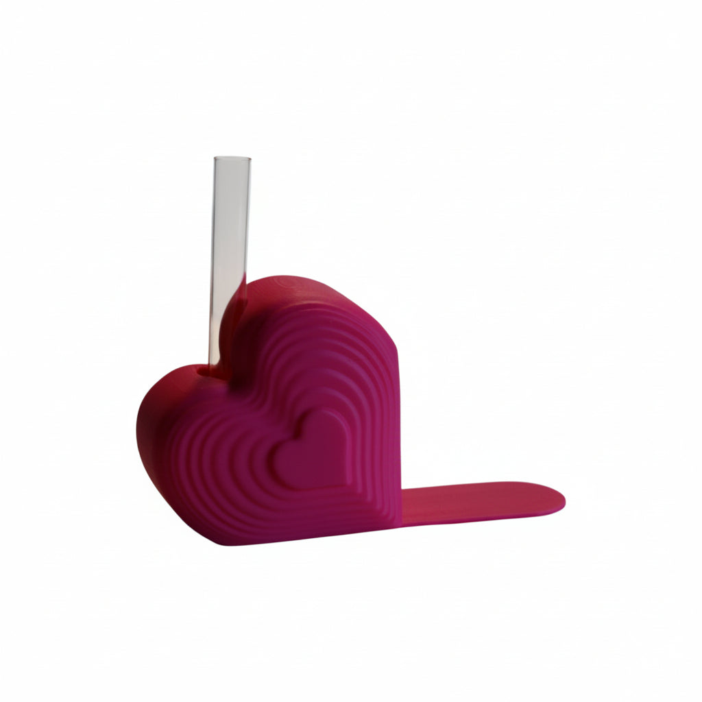 Pink heart bookend that doubles as a test tube vase, styled on a desk with books; romantic shelf decor and Valentine’s gift for book lovers.