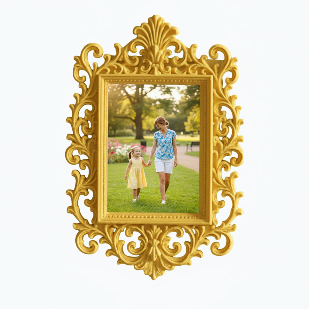 May include: A decorative pink picture frame with an elaborate, swirling design. The frame contains a photograph of a woman and child in a park. The frame is on a white shelf, with pink flowers and a candle.