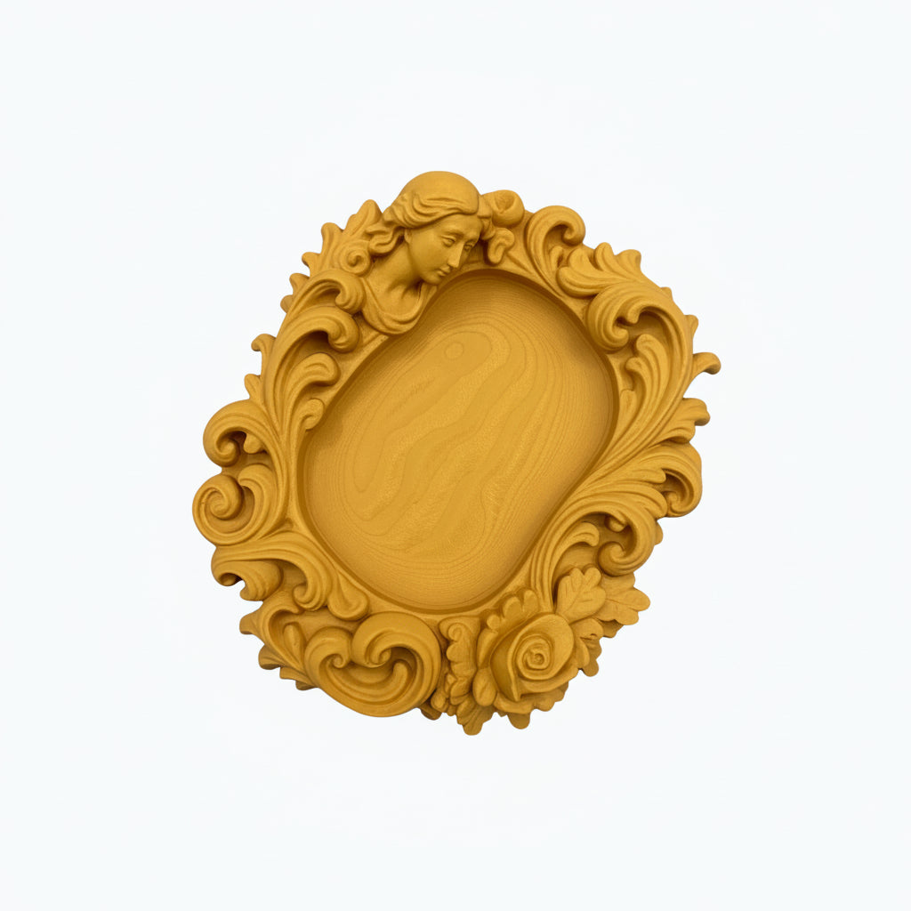 Pink rococo-style woman and rose catchall tray used as a jewelry dish, holding a gold ring, pearl earrings, and a necklace on a vanity surface.