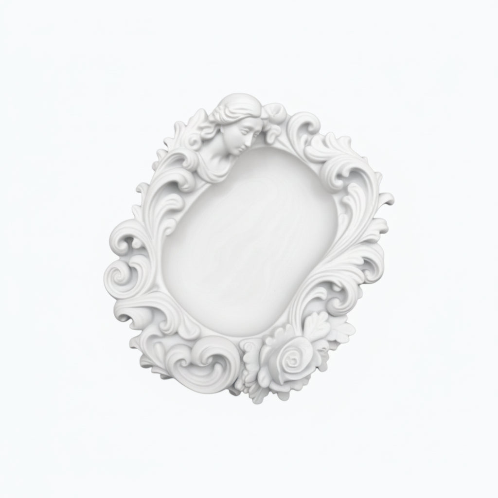 Pink rococo-style woman and rose catchall tray used as a jewelry dish, holding a gold ring, pearl earrings, and a necklace on a vanity surface.