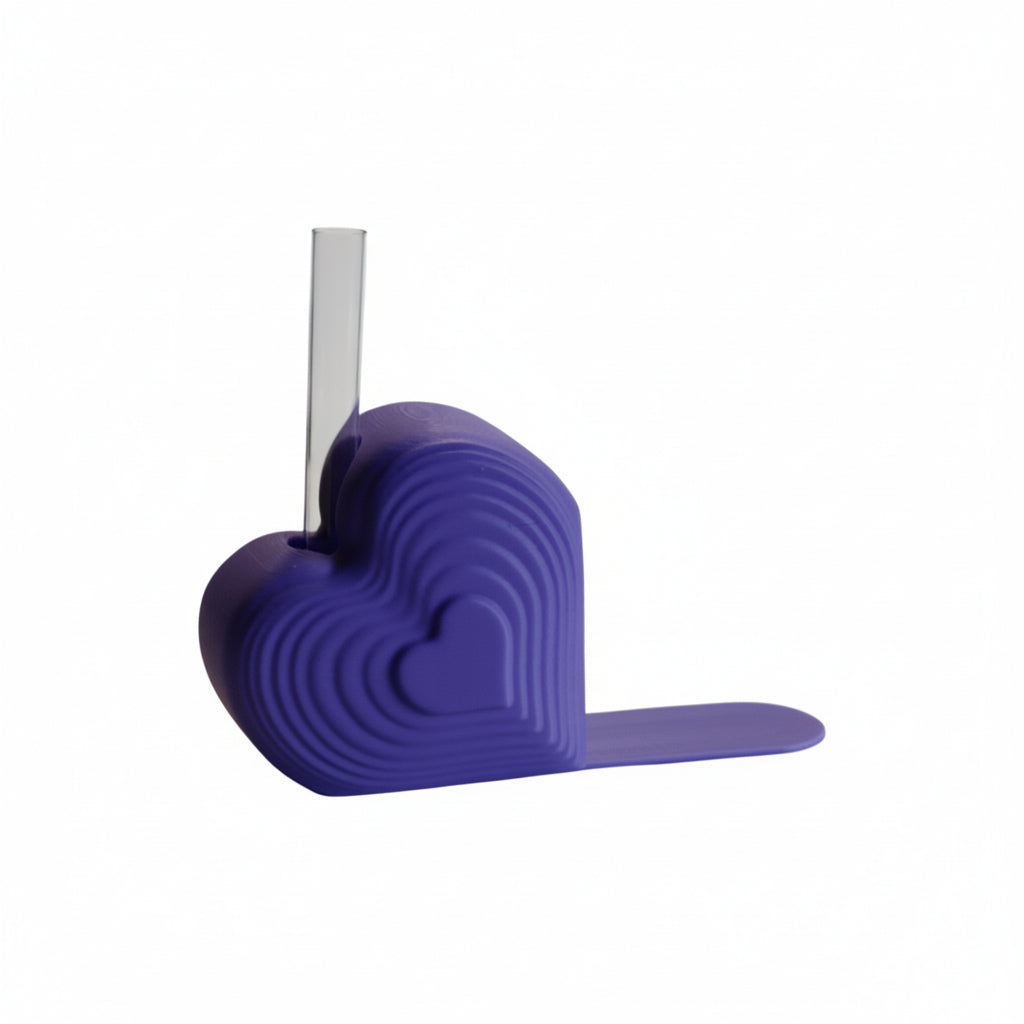 Pink heart bookend that doubles as a test tube vase, styled on a desk with books; romantic shelf decor and Valentine’s gift for book lovers.