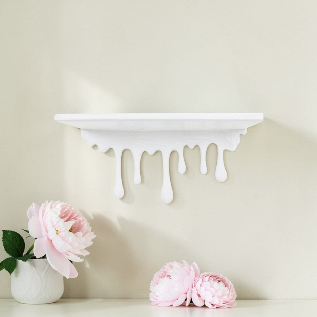 Modern dripping wall shelf with a unique flowing design, mounted on a white wall, showcasing minimalist decor and providing stylish storage for books, plants, or decorative items.