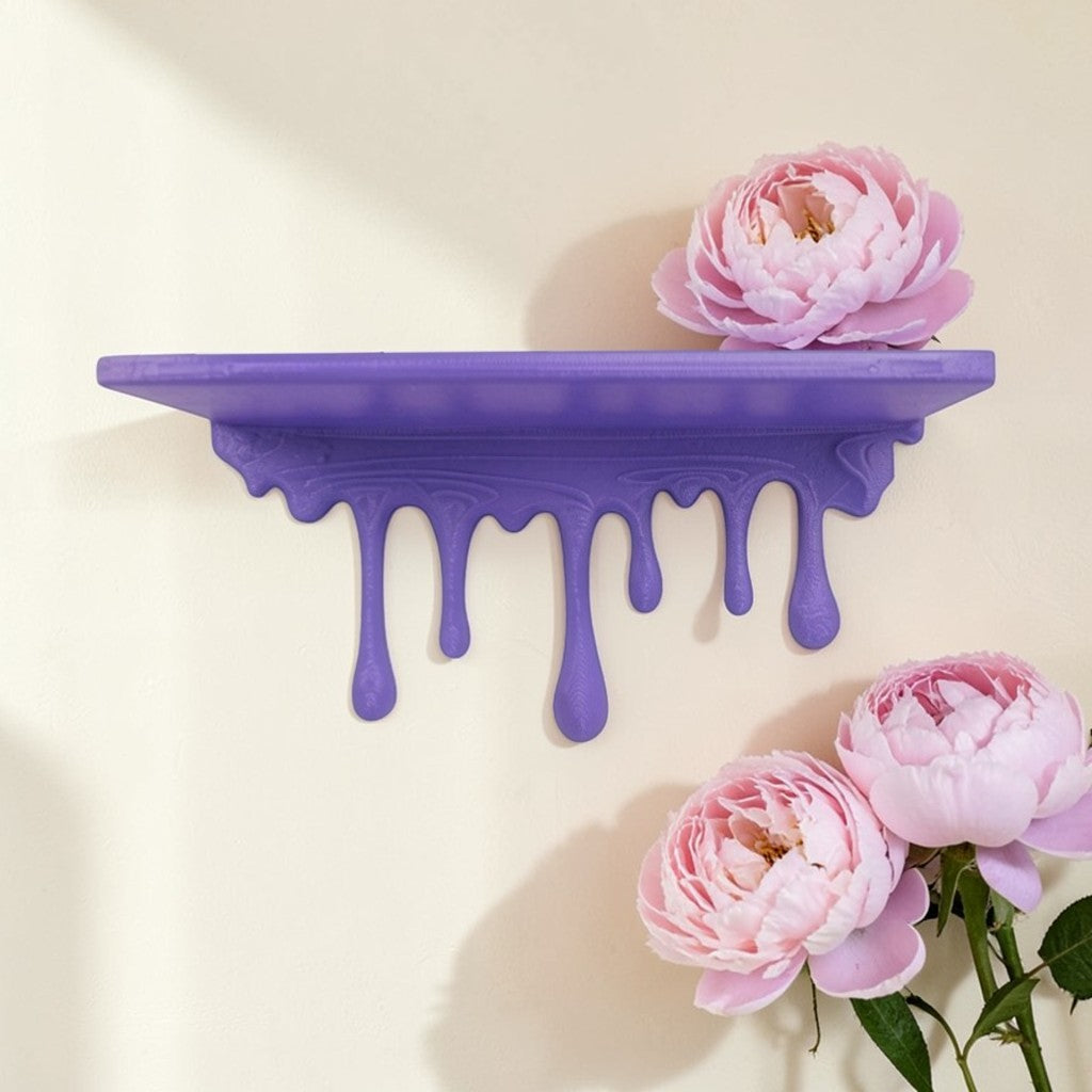 Modern dripping wall shelf with a unique flowing design, mounted on a white wall, showcasing minimalist decor and providing stylish storage for books, plants, or decorative items.