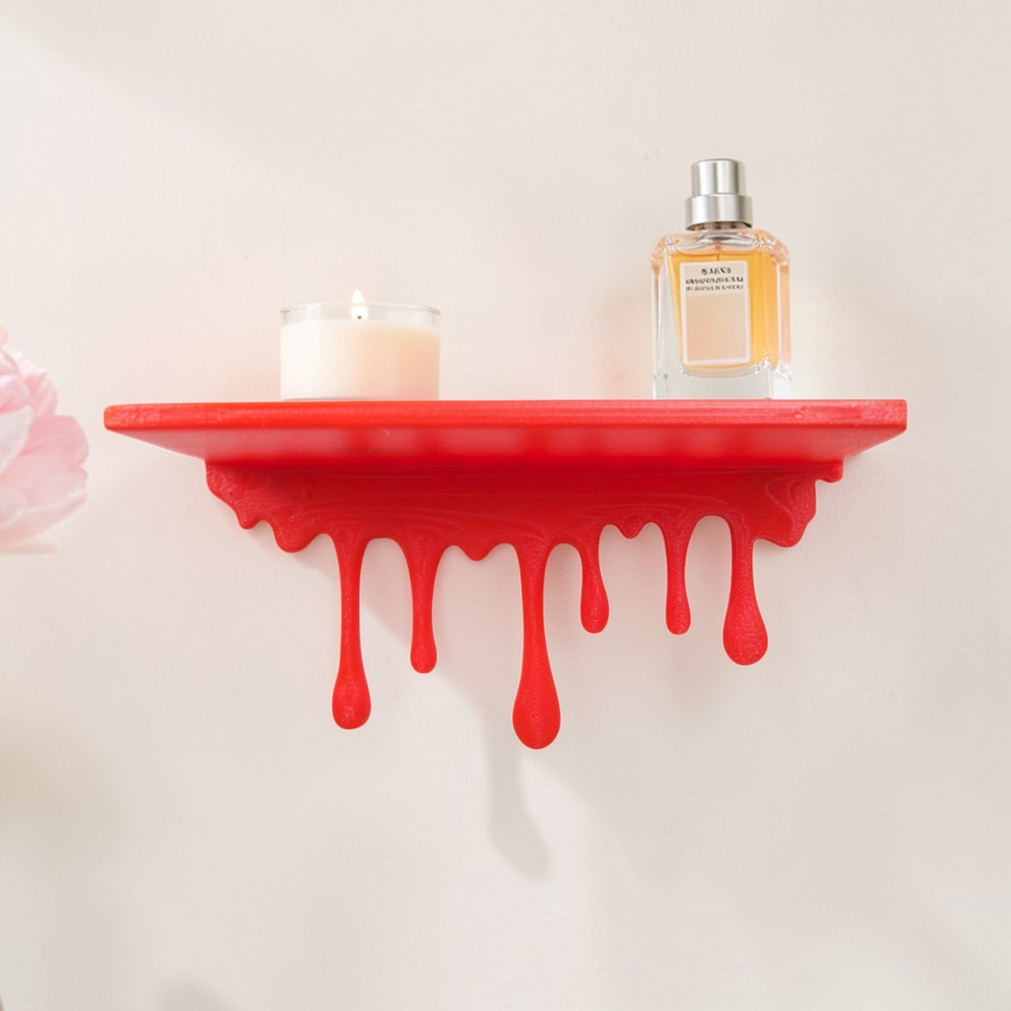 Modern dripping wall shelf with a unique flowing design, mounted on a white wall, showcasing minimalist decor and providing stylish storage for books, plants, or decorative items.