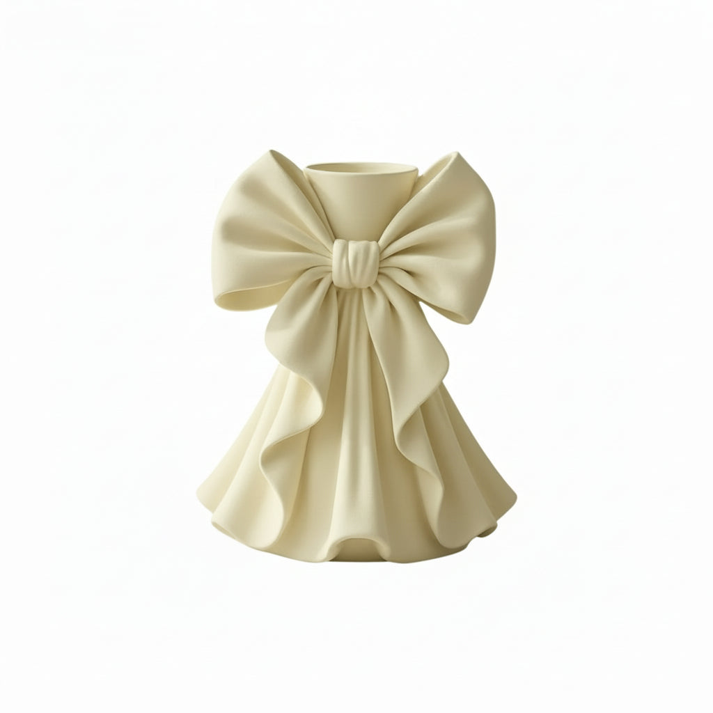 Coquette bow vase with pleated fabric-style design in soft pink on a vanity table
Romantic bow flower vase styled with roses and feminine home decor
Sculptural bow vase with matte finish for bridal and coquette interiors
Feminine decorative vase with gift-inspired silhouette and elegant bow
 Soft aesthetic flower vase designed for romantic and luxury spaces